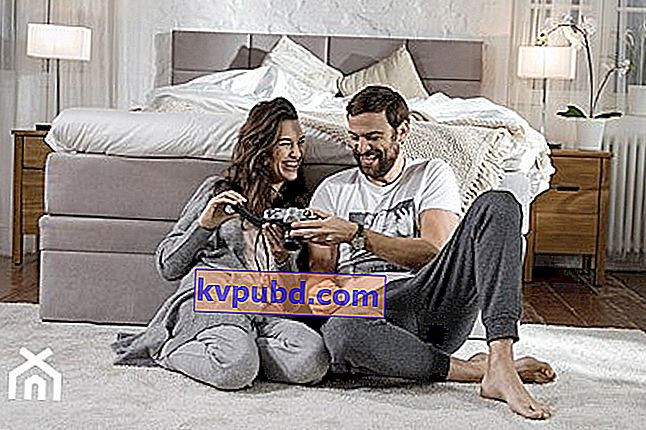 muž a žena prezeranie fotografií v spálni